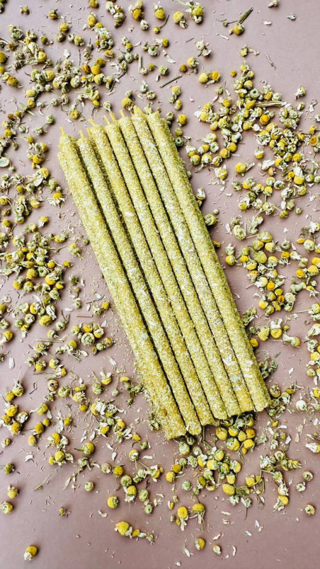 Velas decorativas de cera pura de abeja, enrolladas en flores secas de manzanilla para un ambiente natural y sereno.