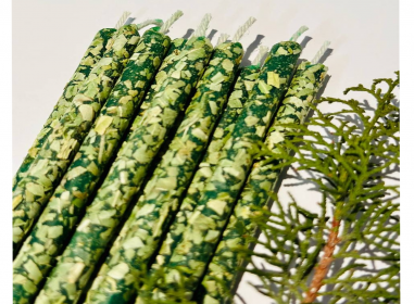 Thin green candles with basil, herbal...